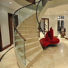 Commercial building wood tread glass baluster curved staircase