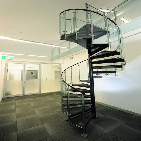 J-attic wooden spiral staircase with glass balustrade 